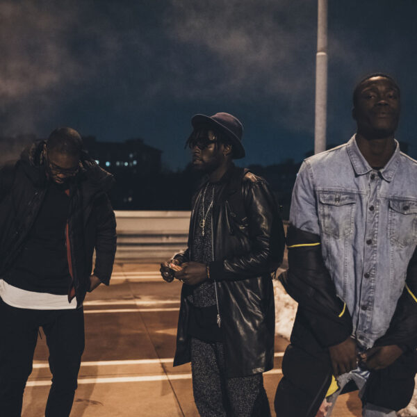 three young men posing outdoor looking camera three young men posing outdoor looking camera serious - rap crew, gang, swag concept
